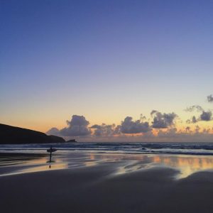 fistral beach in newquay cornwall sunset surfer