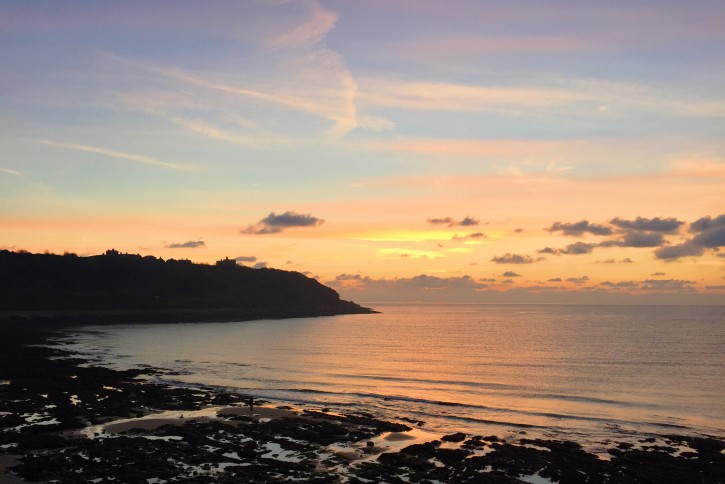 Sunrise in Falmouth over castle beach and Pendennis Point.